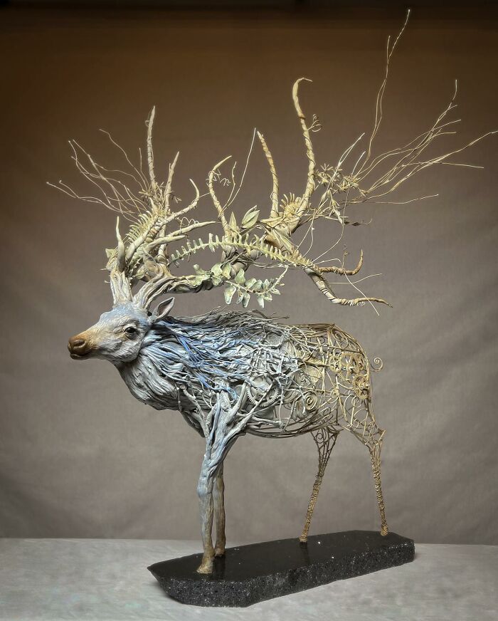 Intricate animal sculpture made from scrap metal featuring a detailed deer with elaborate antlers.