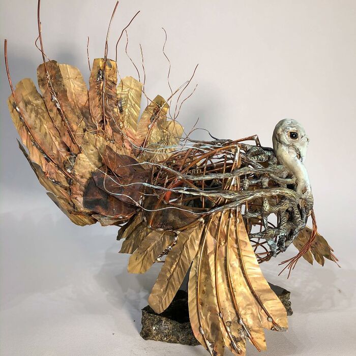 Scrap metal animal sculpture of a bird with detailed wings and textured body, showcasing striking metal artwork craftsmanship.