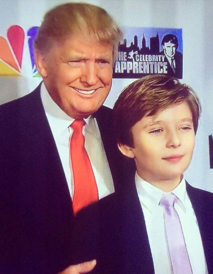 Donald Trump smiling next to young Barron Trump, highlighting Barron Trump&rsquo;s luxury-filled childhood in a formal setting.