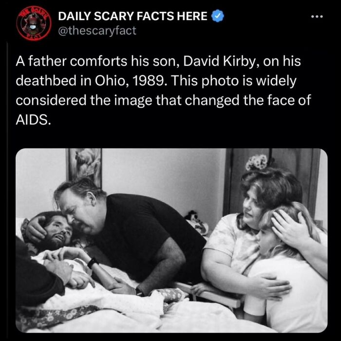 Black and white photo showing a father comforting his son on his deathbed, illustrating a scary fact about AIDS impact.