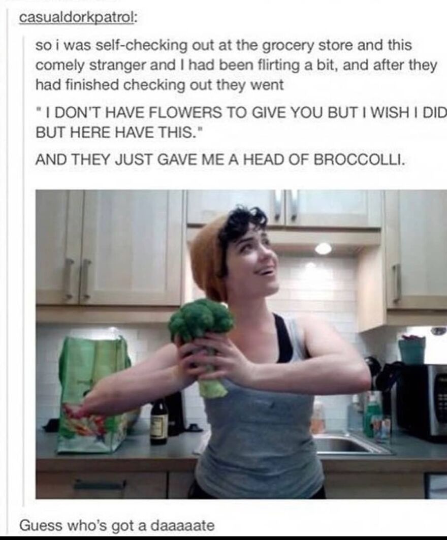 Person in kitchen holding broccoli with a happy expression, illustrating a funny totally true story moment.