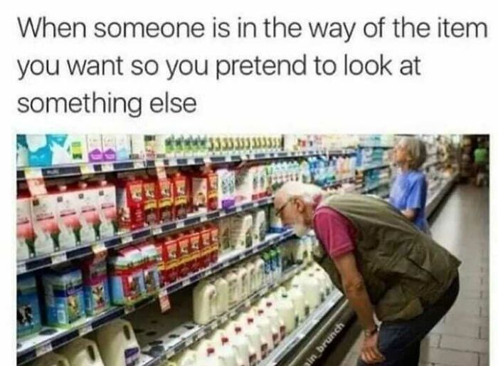 Elderly man awkwardly pretending to look at milk on a grocery store shelf, illustrating social anxiety memes humor.