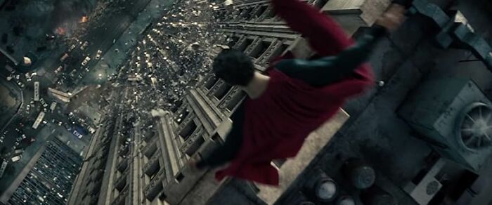 Man in a red cape falling from a skyscraper, illustrating a dramatic scene typical of worst movie tropes quiz topics.