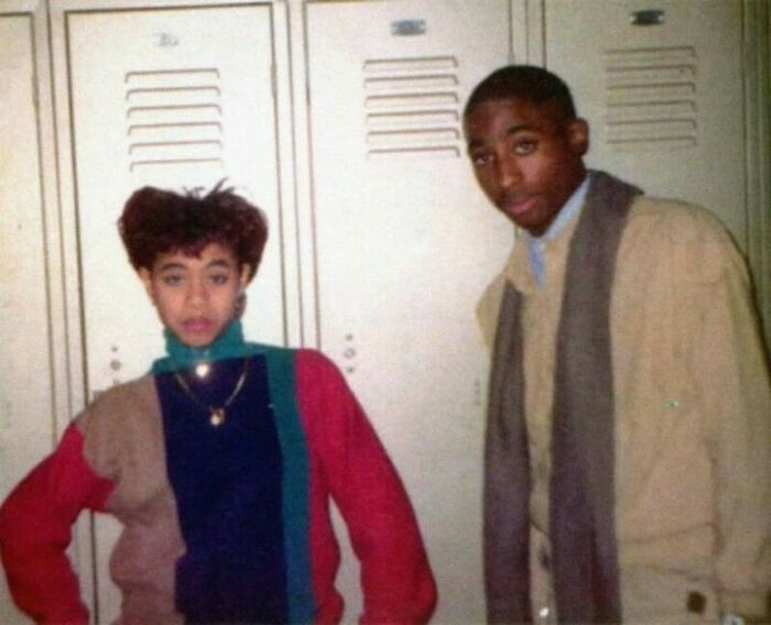 Two young people standing in front of lockers, capturing a moment that fits surprising interesting facts.