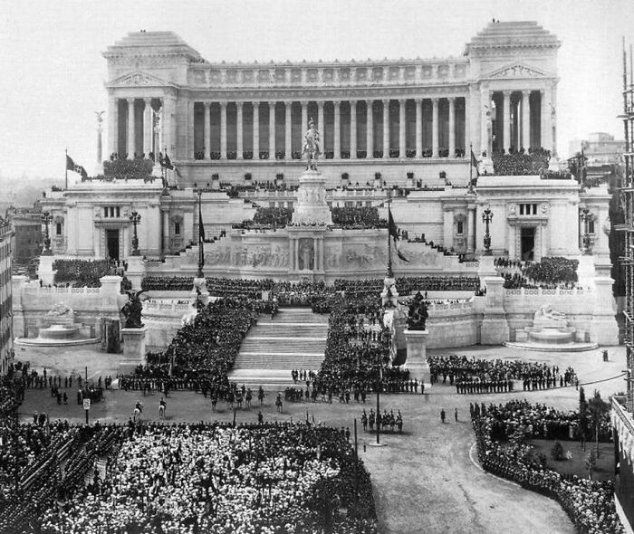 Crowd gathered in front of grand old architecture showcasing historical design and the beauty of our past.