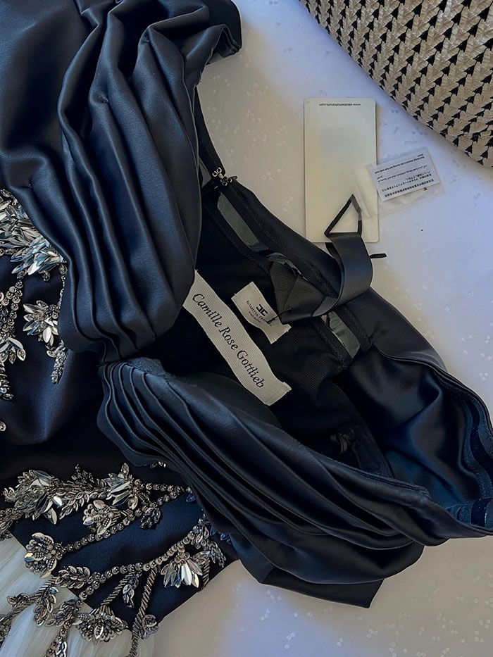 Black embellished gown with luxurious fabric and elegant draping, Grace Kelly&rsquo;s granddaughter style at charity event accessories visible.