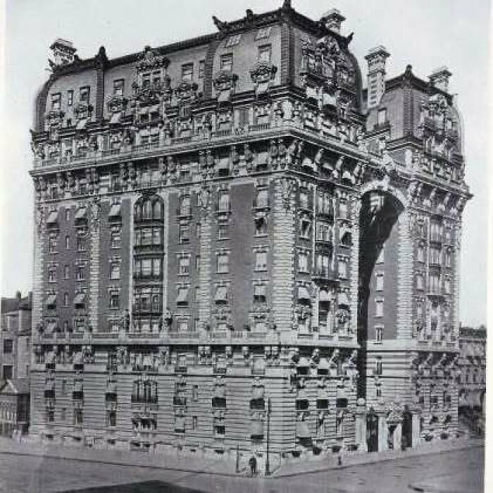Historic old architecture building with intricate stonework and detailed ornamental features in a black and white photo.