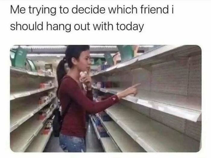 Woman in a store aisle looking thoughtfully at empty shelves representing social anxiety memes about choosing friends to hang out with.