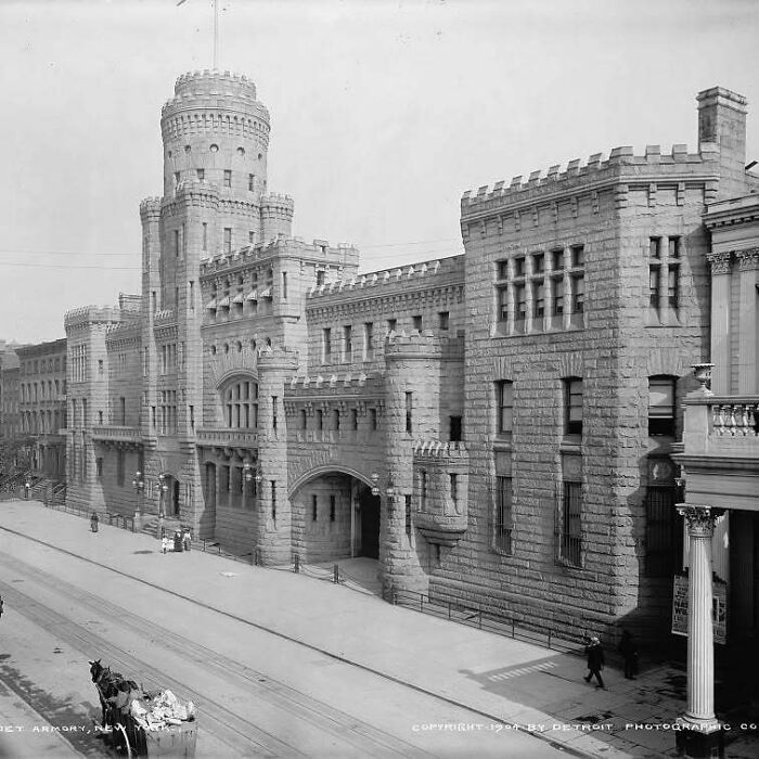 Historic old architecture of a grand stone armory building featuring castle-like towers and intricate masonry details.
