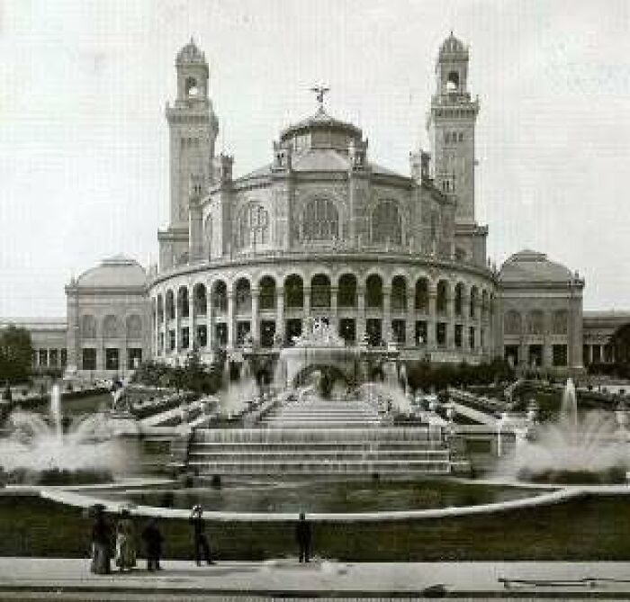 Historic old architecture with large arched windows and towers, showcasing beautiful design from the past era.