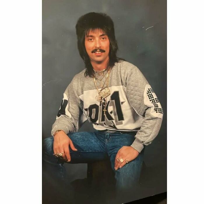 Vintage portrait of a dad from the past wearing 80s fashion and gold chains, embodying old school cool style and attitude