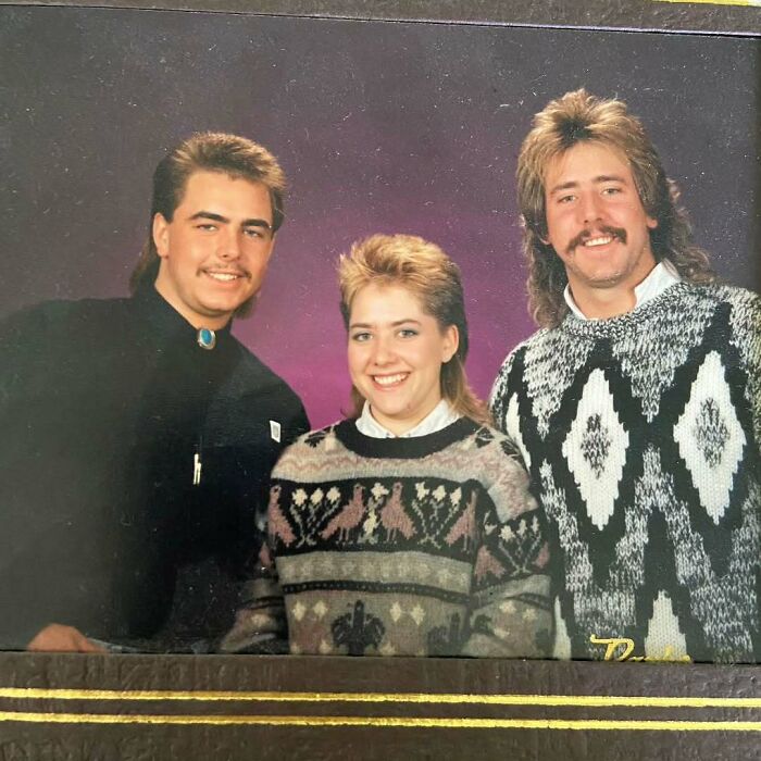 Three people dressed in 80s-style sweaters and hairstyles, capturing old school cool dads from the past.