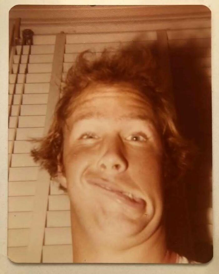 Vintage photo of a dad making a funny face, showcasing old school cool style and personality from the past.