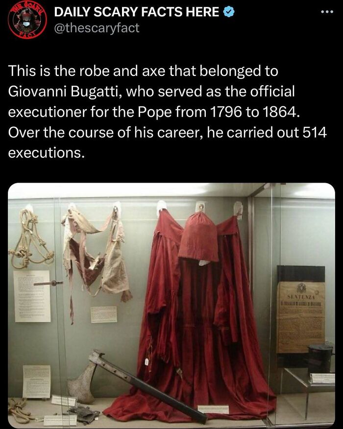Display of the executioner’s robe and axe from the 18th century, showcasing a chilling scary fact in the darkness.