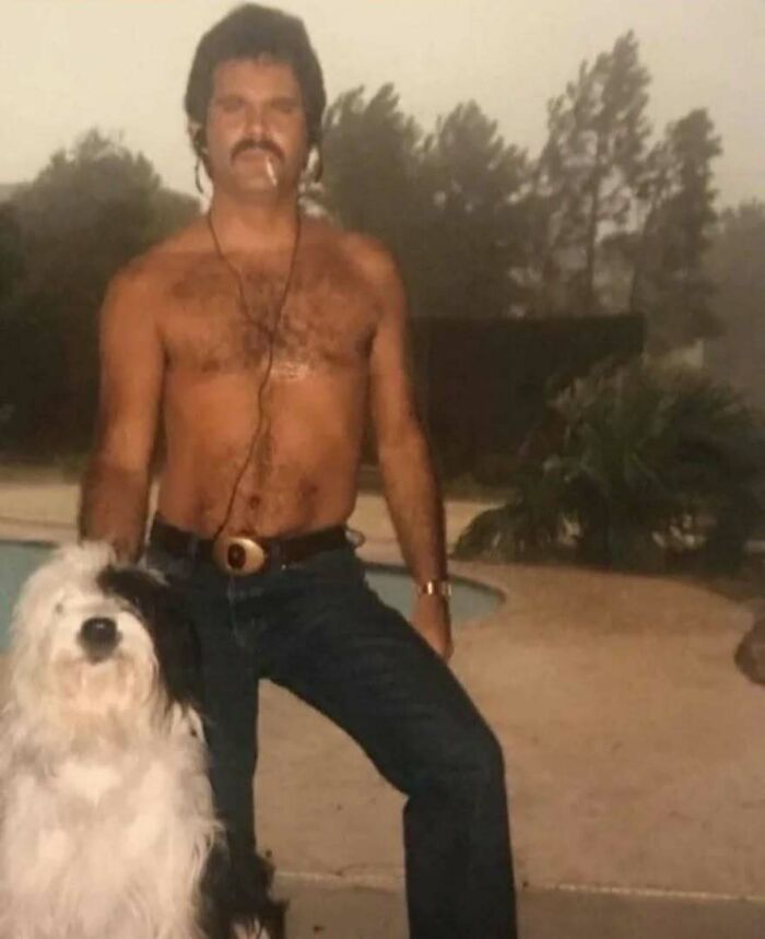 Shirtless vintage dad with mustache and cigarette posing by pool with a fluffy dog, showcasing old school cool style.