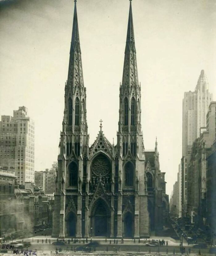 Gothic old architecture featuring twin spires in a historic cityscape showcasing past architectural beauty.