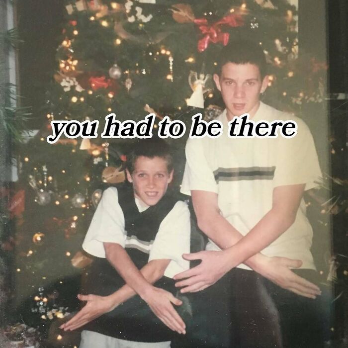 Two boys posing with hand signs in front of a decorated Christmas tree, nostalgic meme for Tamagotchis and VHS tapes fans.