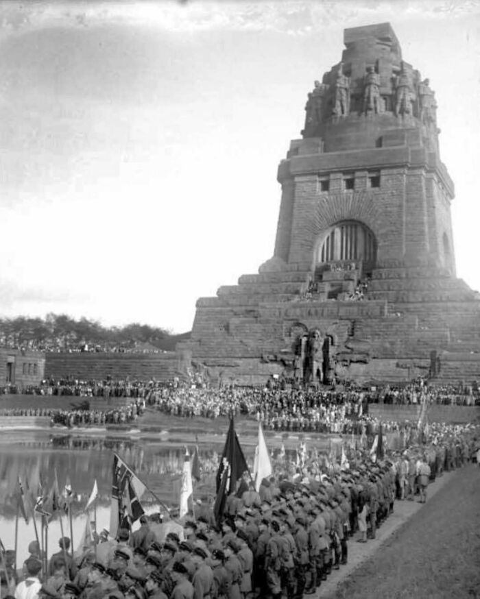 Monumental old architecture with large stone structure and crowd gathered, showcasing historical building beauty.