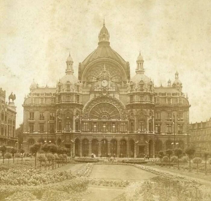 Vintage photo of old architecture showcasing a grand historic building with intricate design and symmetrical towers.