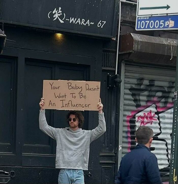 Man holding a cardboard sign with a funny message, part of Dude With The Sign viral social media content.