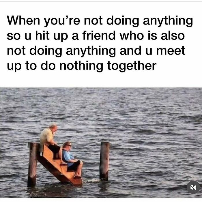Two people sitting on a small staircase in water, illustrating funny memes about not taking life too seriously.