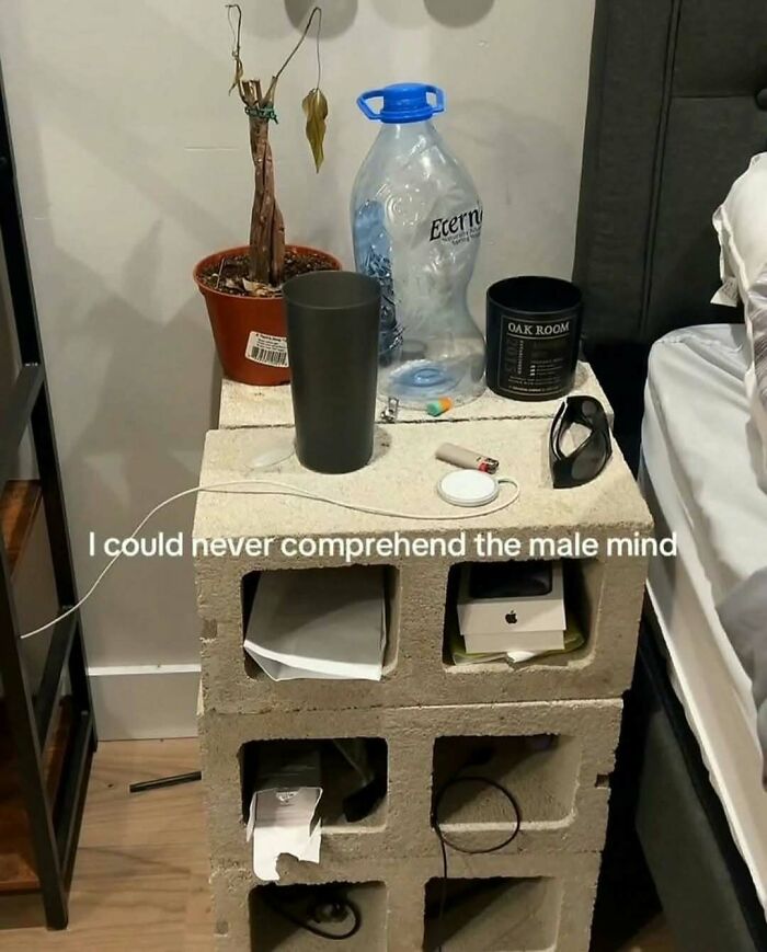Nightstand made of concrete blocks with random items on top, showing a confusing scene from pics that make no sense.