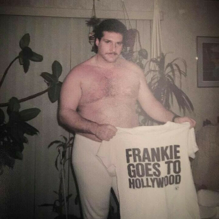 Vintage photo of a shirtless dad holding a Frankie Goes to Hollywood T-shirt, showcasing old school cool style and attitude.