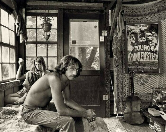 Young man and woman in rustic room with vintage decor, illustrating interesting facts and surprising lifestyle details.