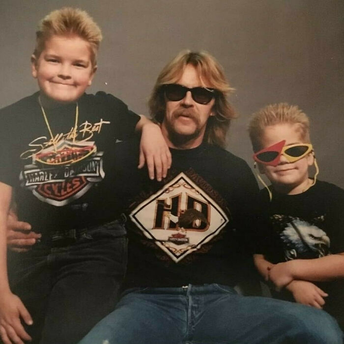 Father and sons in vintage Harley Davidson shirts and cool sunglasses, embodying old school cool style from the past.