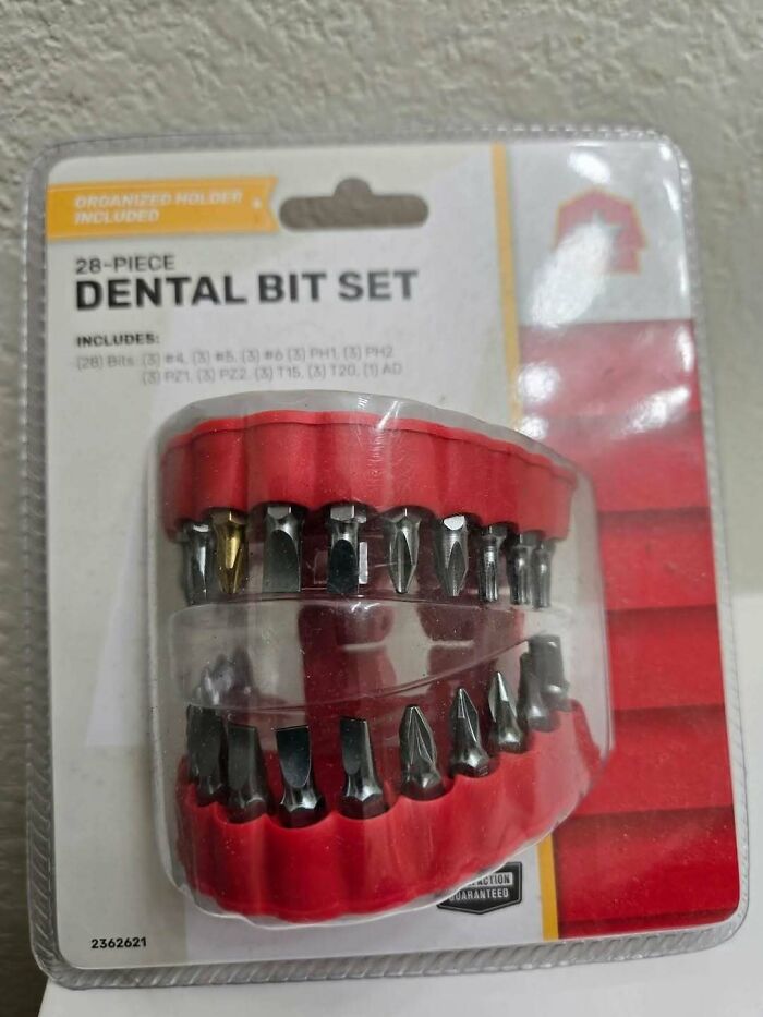 Dental bit set arranged in a red holder designed to look like a set of human teeth, creating a confusing visual effect.
