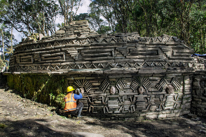 Archaeologists examining ancient stone structures linked to a mysterious ancient civilization in a forested excavation site. - 11