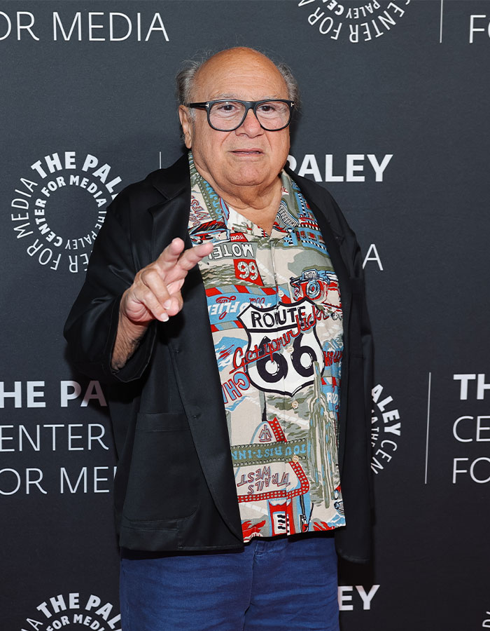Danny DeVito at a media event wearing glasses and a Route 66 shirt responding to fan concerns about Jack Nicholson&rsquo;s health.