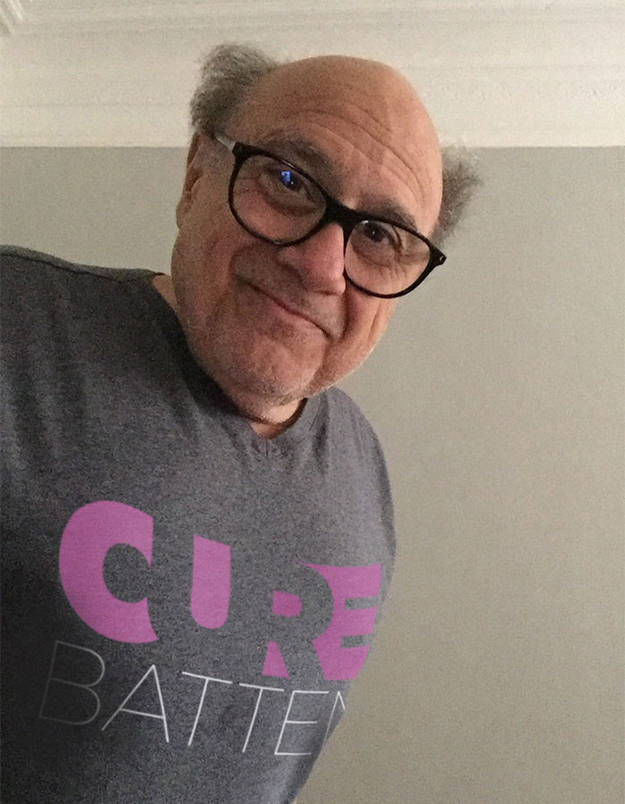 Danny DeVito wearing glasses and a Cure Batten shirt while responding to fan concerns about Jack Nicholson&rsquo;s health.