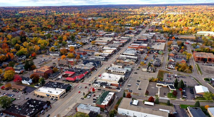 Aerial view of a small town in fall with colorful trees, showcasing one of the best places to live in the USA.