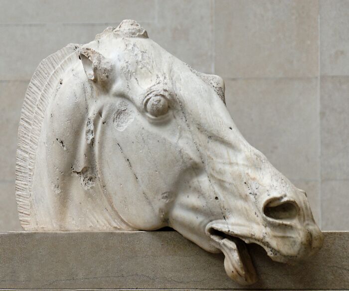 Marble horse head sculpture displayed as one of the foreign artifacts held in the British Museum collection.
