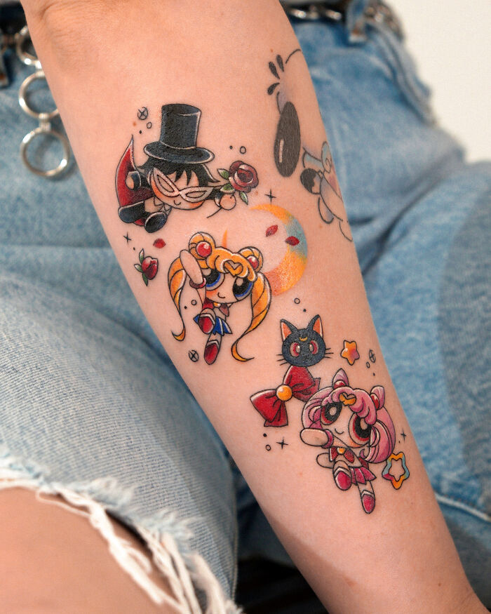 Colorful anime-style tattoos on forearm featuring characters and symbols in a unique, playful design, showcasing best tattoos.