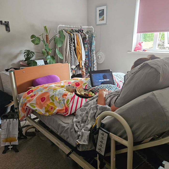 Patient lying in bed with floral blanket and laptop, illustrating mom ends her life by starving to protect kids. - 6