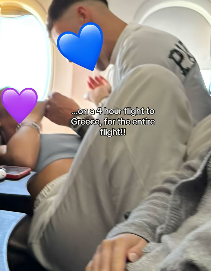 Couple showing PDA on a plane during a flight, sparking passenger fumes over disrespectful behavior in the cabin. - 2