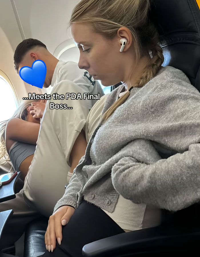 Passenger visibly annoyed by a PDA act on plane, sparking debate over disrespectful behavior during flight. - 3