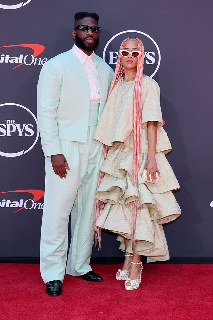 Two sports stars posing on the red carpet at the 2025 ESPYs wearing bold and unique fashion choices.