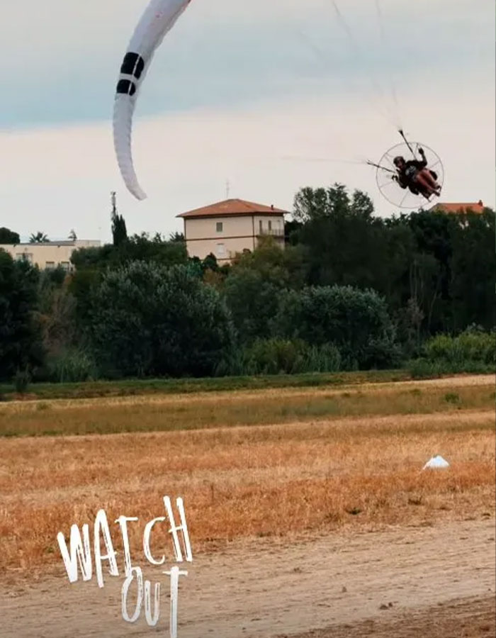 Paramotor skydiver flying low over a field with text watch out, linked to daredevil skydiver final moments viral post Paramotor skydiver flying low over a field with text watch out, linked to daredevil skydiver final moments viral post