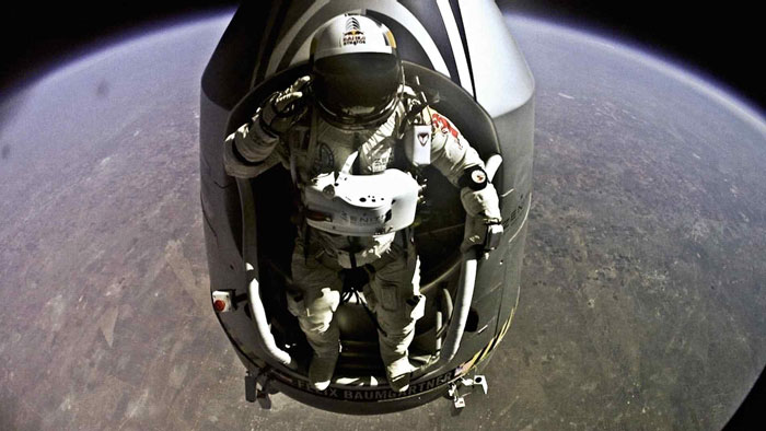 Skydiver in a spacesuit exiting capsule mid-air during a high-altitude jump before fatal crash into crowded pool. Skydiver in a spacesuit exiting capsule mid-air during a high-altitude jump before fatal crash into crowded pool.
