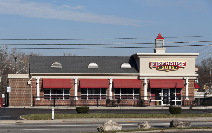 Firehouse Subs restaurant building under clear sky, illustrating places on the brink of collapse in the internet age. - 28