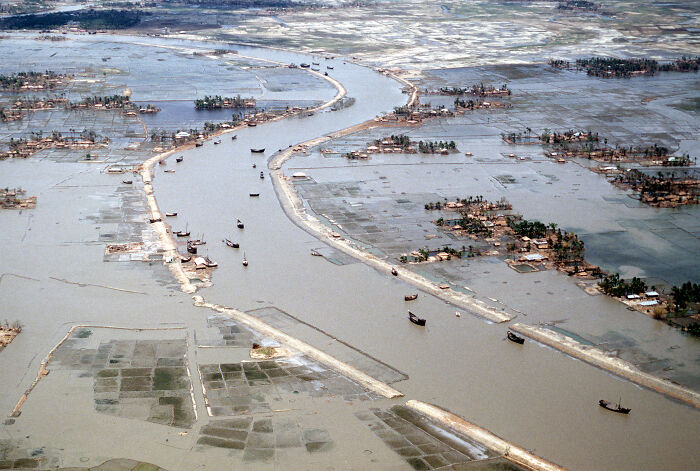 Aerial view of extensive flooding with boats navigating submerged lands after one of the largest natural disasters in the last century.