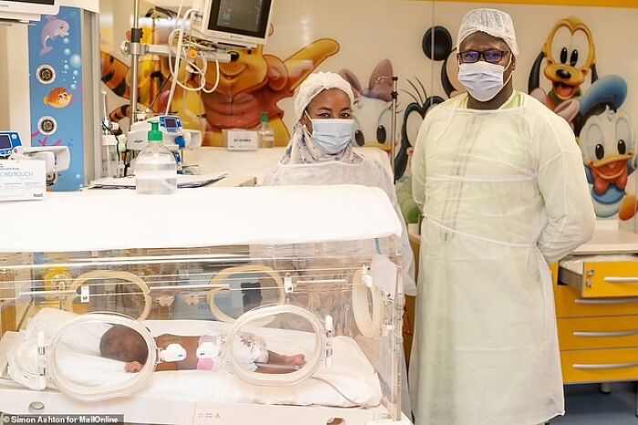 Medical staff in protective gear attending to the world&rsquo;s first surviving nonuplets in a hospital nursery.