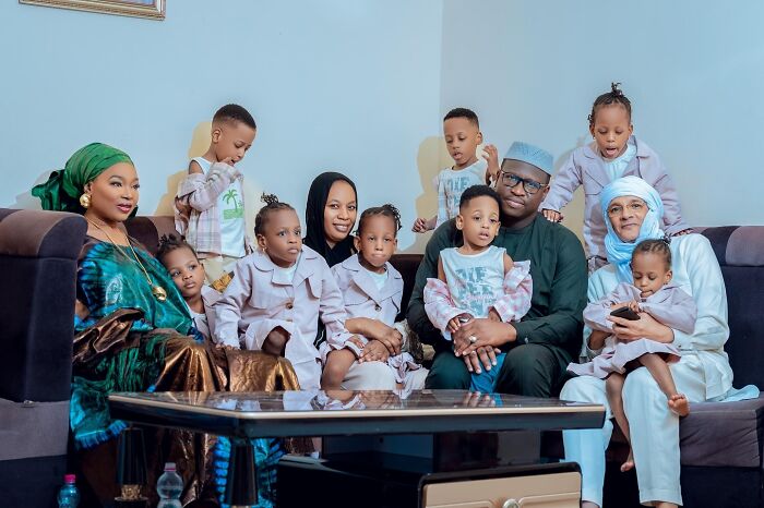 The world&rsquo;s first surviving nonuplets with family members sitting together in a living room celebrating their 4th birthday