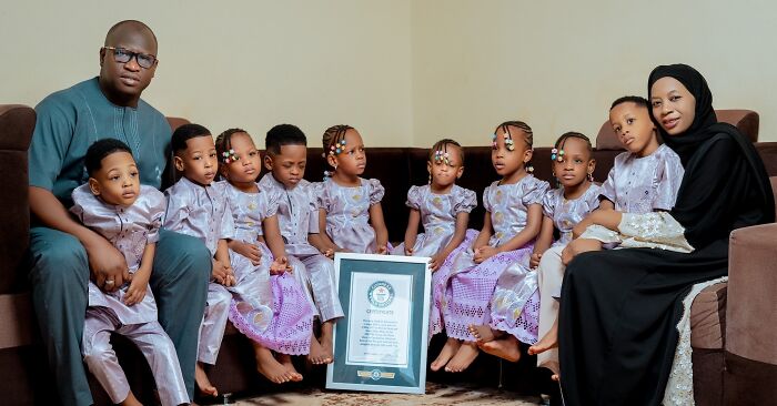 The world&rsquo;s first surviving nonuplets sitting with parents, dressed in matching outfits, celebrating their fourth birthday.