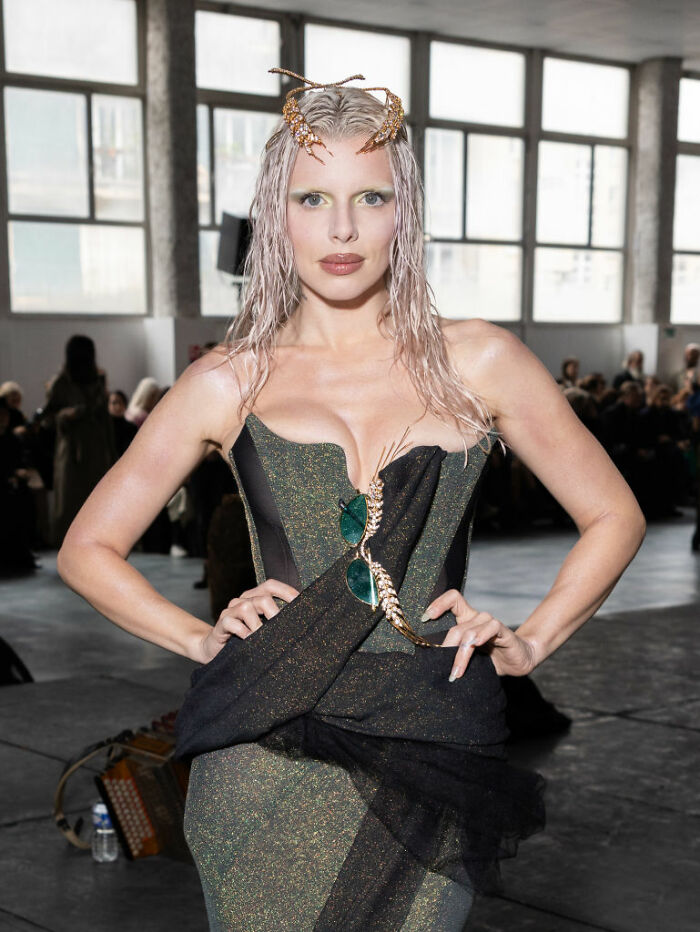 Model showcasing elegant fashion at an event, illustrating celebrities that choose not to overspend despite wealth.