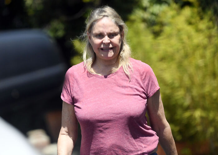 Bond girl aged 70 wearing a pink shirt, smiling outdoors in rare public sighting 35 years after film with Timothy Dalton. Bond girl aged 70 wearing a pink shirt, smiling outdoors in rare public sighting 35 years after film with Timothy Dalton.