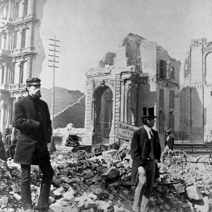 Men stand among rubble and ruins in a 19th century historical photo capturing a moment that made history come alive.
